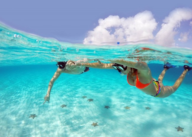 A couple enjoying the crystal clear waters of Cozumel.