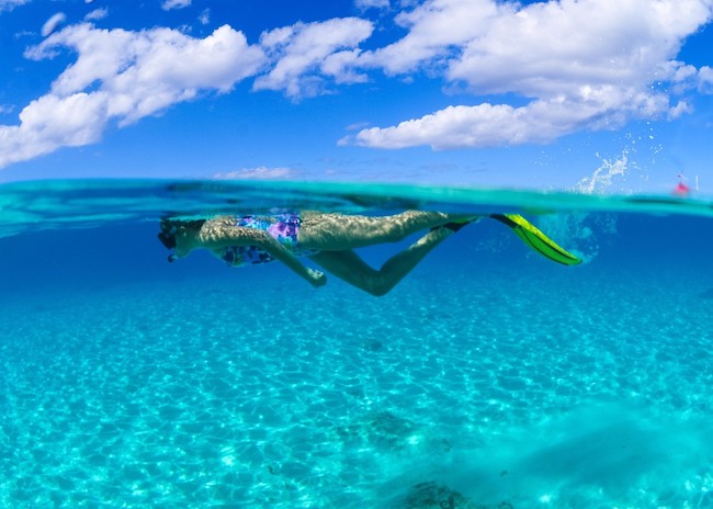A young girl snorkeling on a reef in the Riviera Maya.